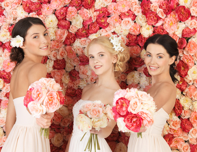 three women with background full of roses